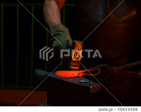 Blacksmith working with metal 50633498