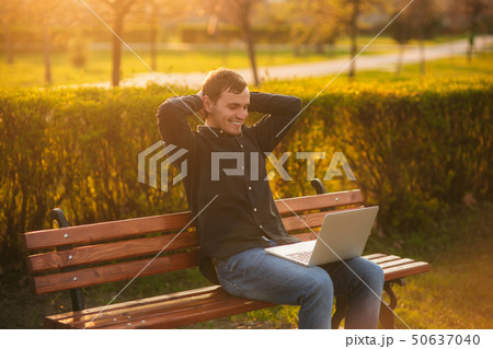 Young businessman finish work on his laptop in the park. Work in internet. Online business 50637040