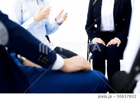 Group of people sitting in a circle during therapy. Meeting of business team participating in 50637832