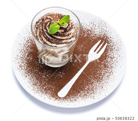 Classic tiramisu dessert in a glass on plate with fork silhouette isolated on a white with clipping 50638322