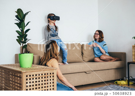 Little child girl playing game in virtual reality glasses Little child girl playing game in virtual reality glasses 50638923