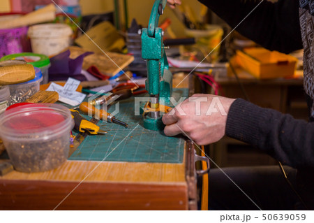 Skinner working with leather belt Skinner working with leather belt 50639059