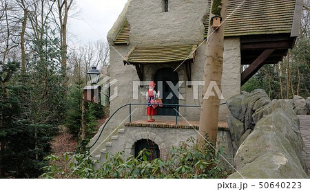 Little Red Hood near the door of a house in Theme Park Efteling. Spring. Little Red Hood near the door of a house in Theme Park Efteling. Spring. 50640223