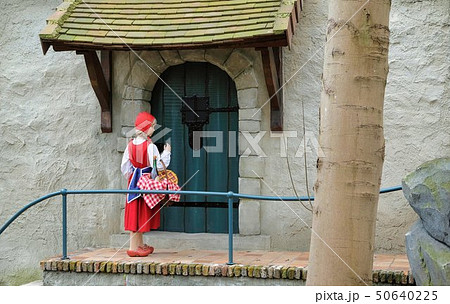 Little Red Hood near the door of a house in Theme Park Efteling. Spring. Little Red Hood near the door of a house in Theme Park Efteling. Spring. 50640225