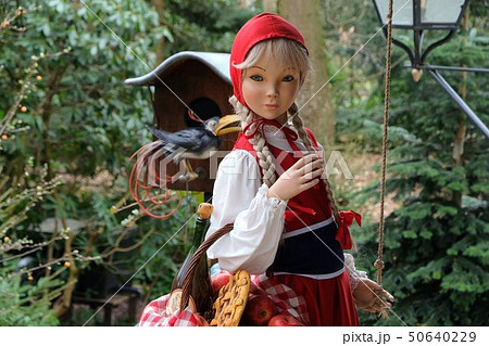 Little Red Hood near the door of a house in Theme Park Efteling. Spring. Little Red Hood near the door of a house in Theme Park Efteling. Spring. 50640229