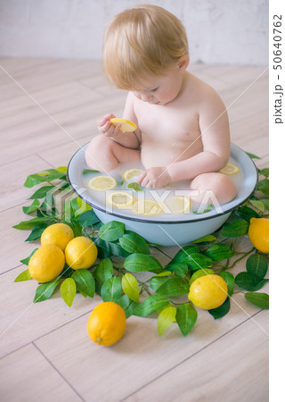 baby boy in an antique milk bath with fresh fruit baby boy in an antique milk bath with fresh fruit 50640762