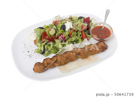 Caucasian lula kebab and adjika with salad. 50641739