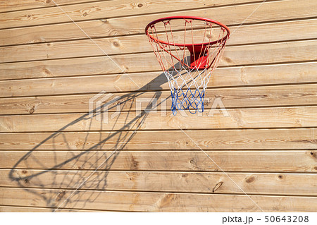Basketball hoop hanged on wooden board background. Playground on backyard of home. Sport equipment 50643208