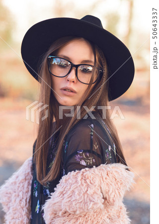 Beautiful girl in a fashionable pink lama coat. 50643337