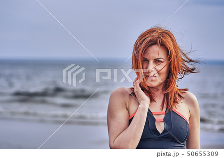 Portrait of a middle-aged woman with red hair 50655309