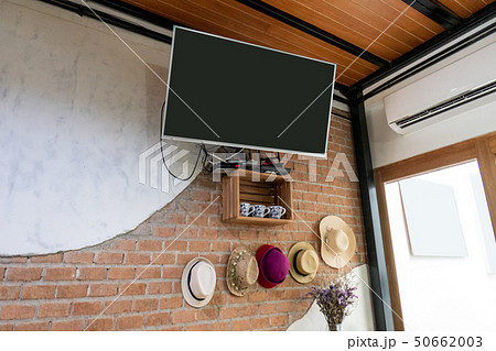 Flat TV hanging on brick wall 50662003