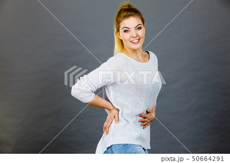 Happy woman touching her stomach and back Happy woman touching her stomach and back 50664291