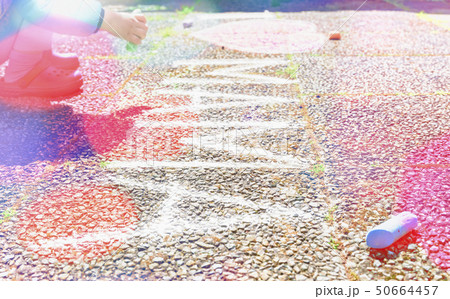Boy drawing on sidewalk with chalk Boy drawing on sidewalk with chalk 50664457