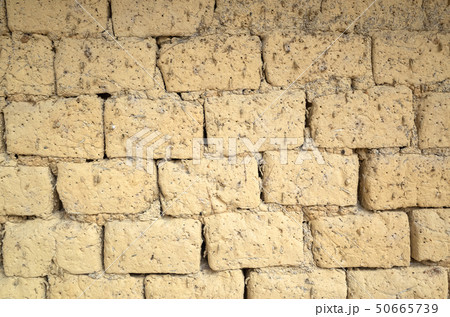 old yellow mud brick wall background old yellow mud brick wall background 50665739