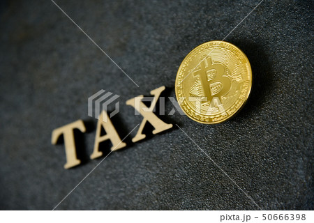 Bitcoin and wooden letters TAX on stone background 50666398
