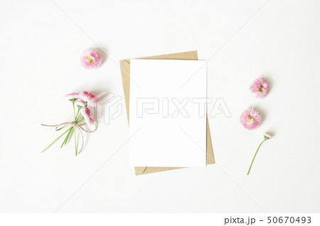 Feminine stationery, desktop mock-up scene. Vertical blank greeting card, craft paper envelope and 50670493