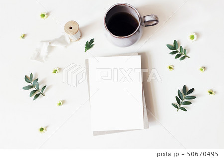 Floral lifestyle, stationery scene. Santini Chrysanthemum flowers, lentisk leaves and cup of coffee 50670495