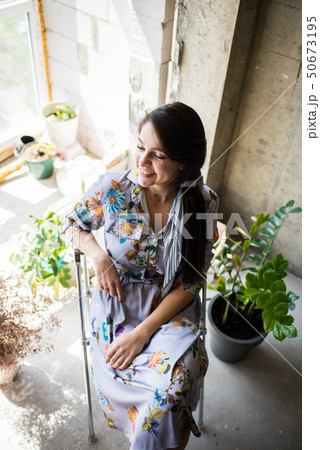 Beautiful young lady artist sitting in her bohemian artistic studio loft 50673195