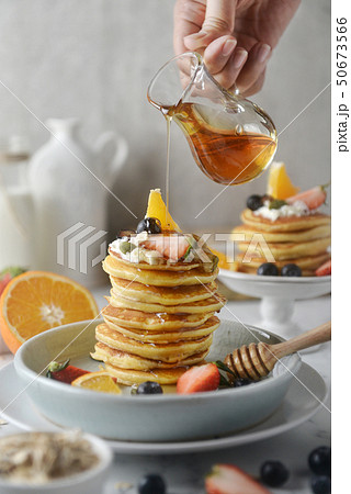 Delicious pancakes, with honey pouring. Delicious pancakes, with honey pouring. 50673566