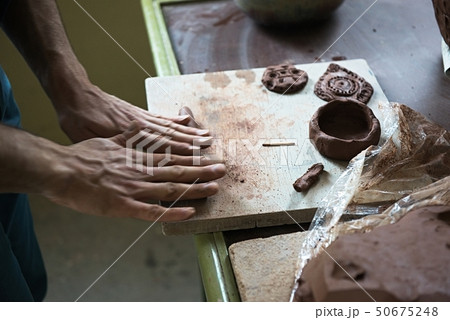 A lace maker and ceramicist create artwork 50675248