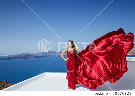 Young beautiful woman in red dress 50676322