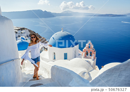 Beautiful young woman against Santorini Beautiful young woman against Santorini 50676327