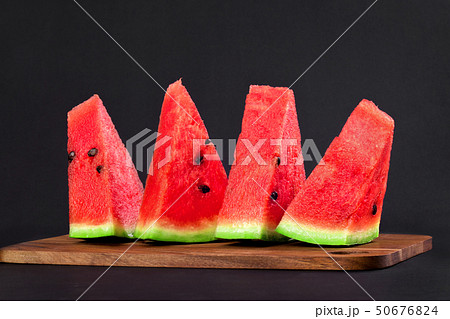 Four triangular wedges of watermelon 50676824