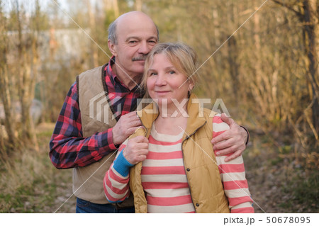 Senior woman and man walking in park 50678095