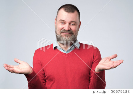man showing I have no idea gesture, shrugging shoulders and raising hands 50679188
