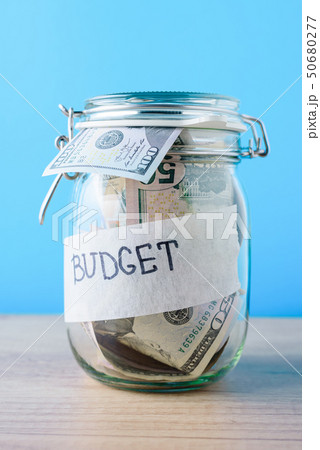 saving bank with dollar bills on a blue background saving bank with dollar bills on a blue background 50680277