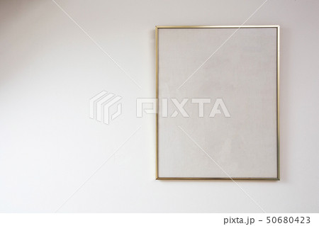 Blank painting on white wall with golden frame, space for text 50680423
