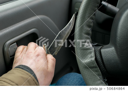 View of the knife in the hand of the driver View of the knife in the hand of the driver 50684864