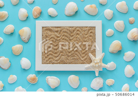 White frame with sea sand and starfish, seashells on blue background. Creative Flat lay Top view White frame with sea sand and starfish, seashells on blue background. Creative Flat lay Top view 50686014