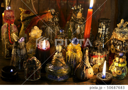 Magic bottles and candles on witch table 50687683