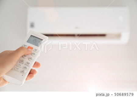 Woman hand holding air remote controller  50689579
