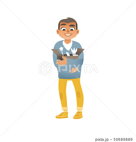 A boy in jeans, sweaters and sneakers holds a box with children toys. 50689889