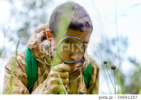 Picture of environmentalist man with magnifying glass 50691267