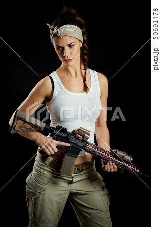 woman posing in a military outfit and a rifle woman posing in a military outfit and a rifle 50691478