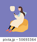 Beautiful caucasian woman sitting on a puff chair using smartphone, vector illustration on blue 50693364
