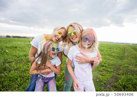 Festival of Holi, friendship and holidays concept - young female people on the color dancing and Festival of Holi, friendship and holidays concept - young female people on the color dancing and 50693406