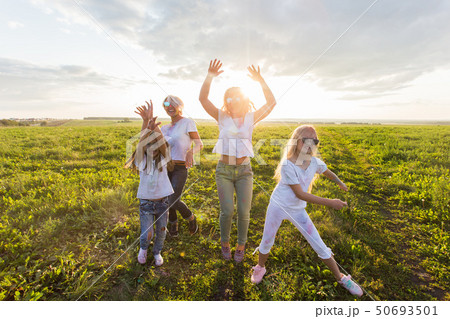 Fun, colors, Indian holidays and people concept - young female people having fun on the festival of Fun, colors, Indian holidays and people concept - young female people having fun on the festival of 50693501