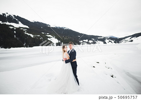Loving husband and woman on the background of the mountains. Loving couple emotionally spends time Loving husband and woman on the background of the mountains. Loving couple emotionally spends time 50695757