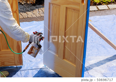 Master painting wood doors with spray gun Master painting wood doors with spray gun 50696717