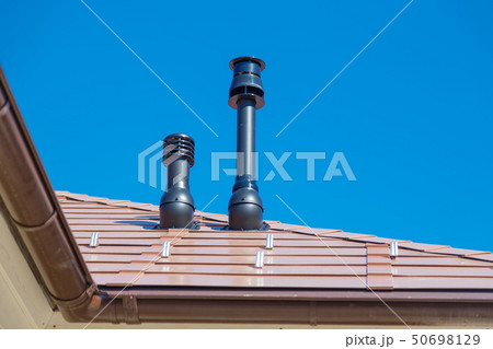 Exhaust pipe on the private house roof 50698129