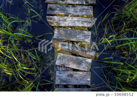 Boards of the old rustic wooden jetty 50698552