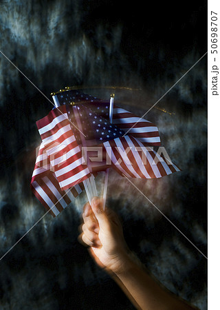 man waving some american flags 50698707