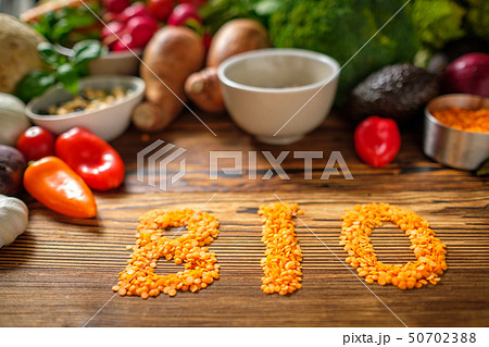 Assortment of fresh vegetables on wooden background Assortment of fresh vegetables on wooden background 50702388