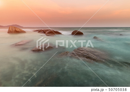 The rock and the sea in the color of sunset. The rock and the sea in the color of sunset. 50705038
