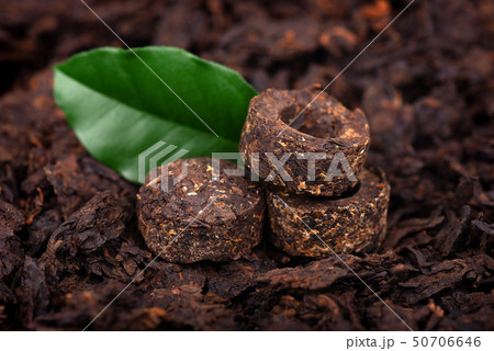 Aromatic black pu-erh tea. Fermented and compressed Leaves into bricks. Round flat disc of puer tea 50706646