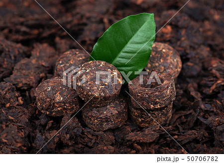 Aromatic black pu-erh tea. Fermented and compressed Leaves into bricks. Round flat disc of puer tea 50706782